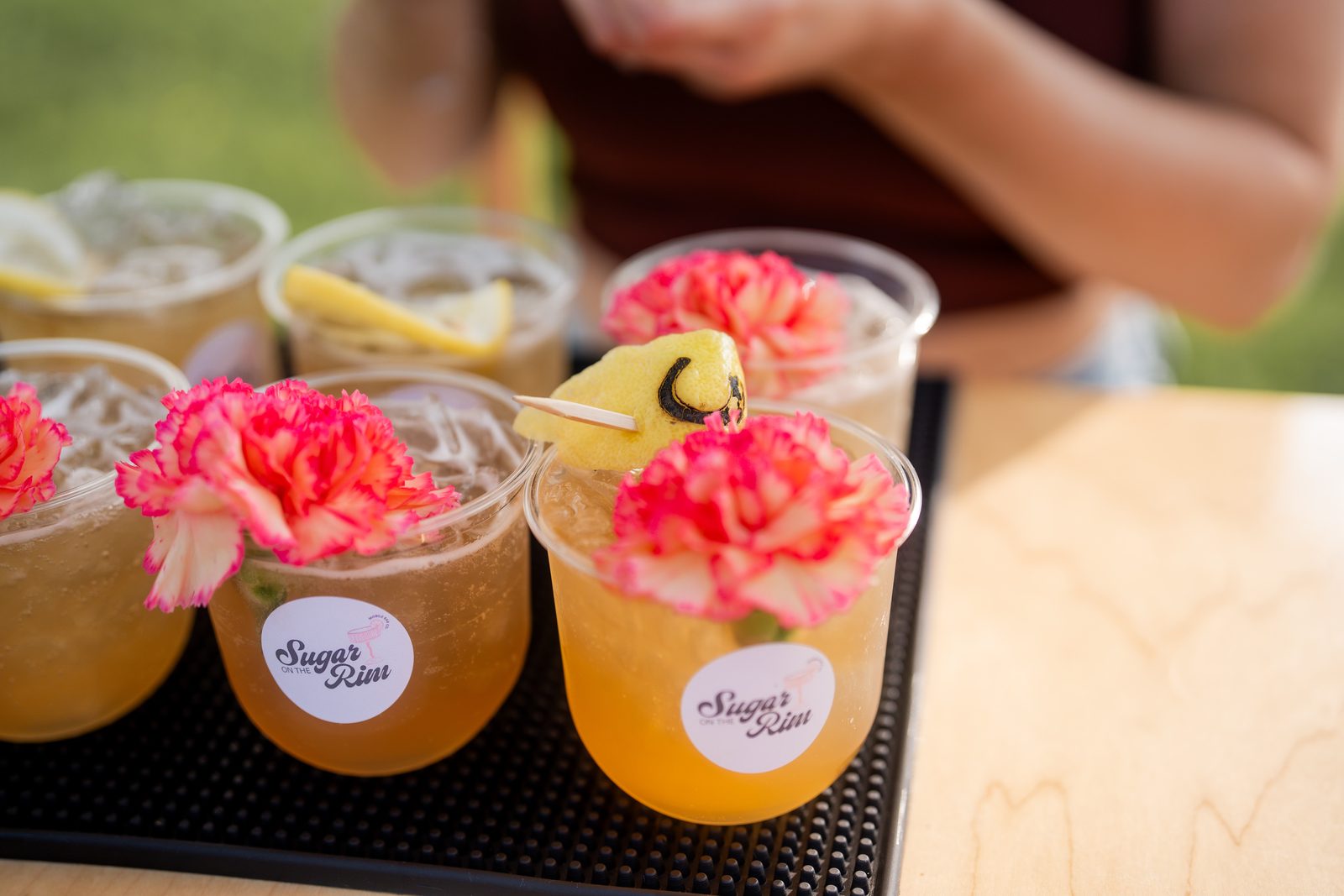 Cocktails lined up on a Sugar On The Rim bar